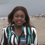 Joy Addison reporting on beach